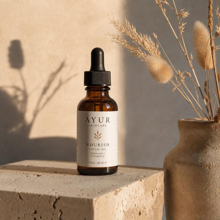 Example AI product photo: amber dropper bottle on a stone block in warm side light